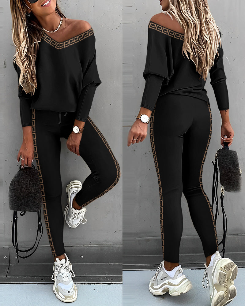 Two piece gigot sleeve top and trousers set in black, front view