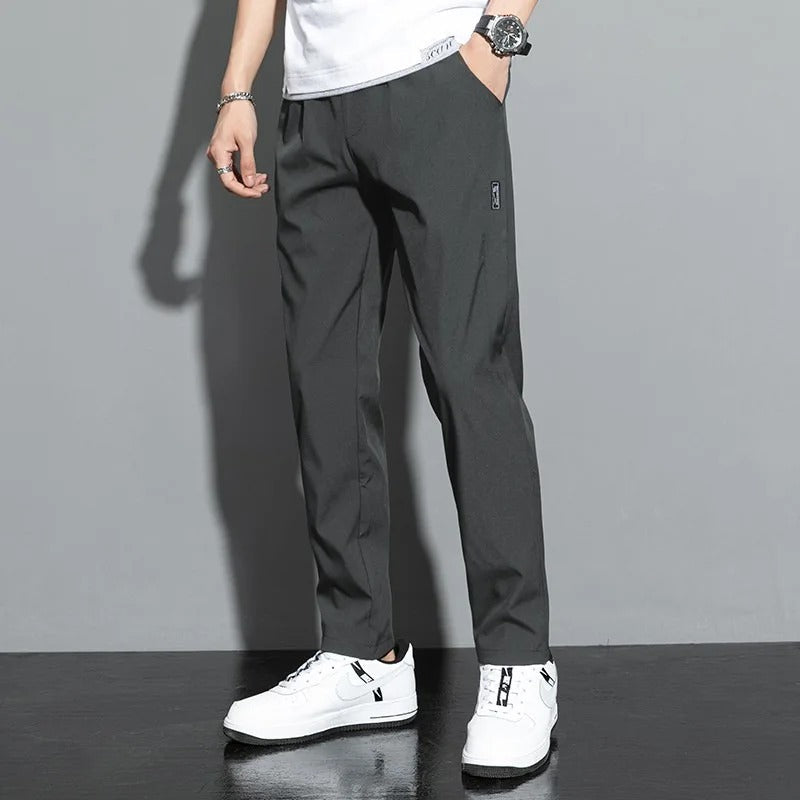 Sporty joggers with drawstring waist in light grey, front view
