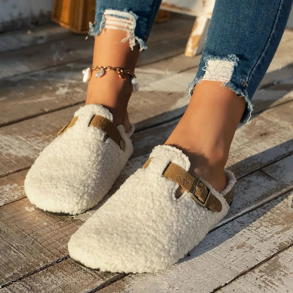 Sheepskin-look wool slippers in beige, shown as cosy slip-on winter mules