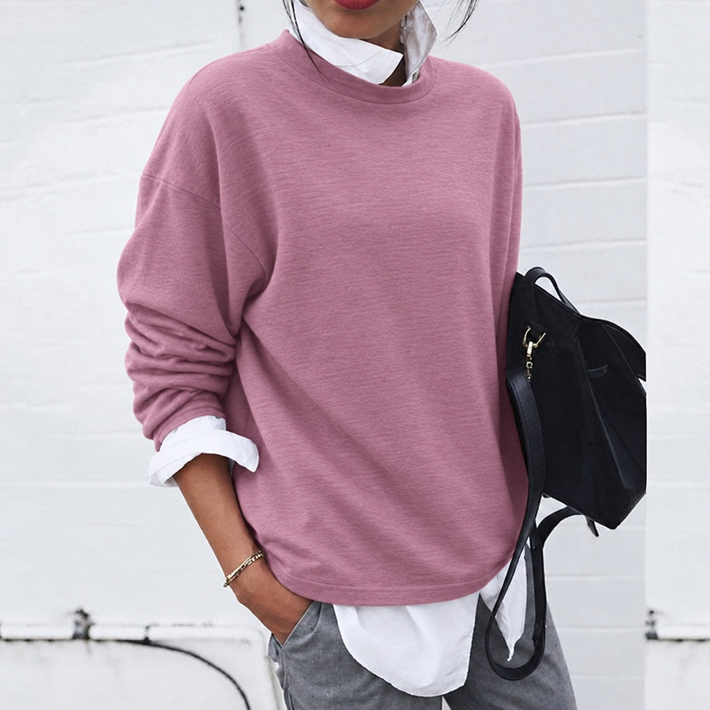 Green lightweight round neck jumper layered over a white shirt, worn by a model