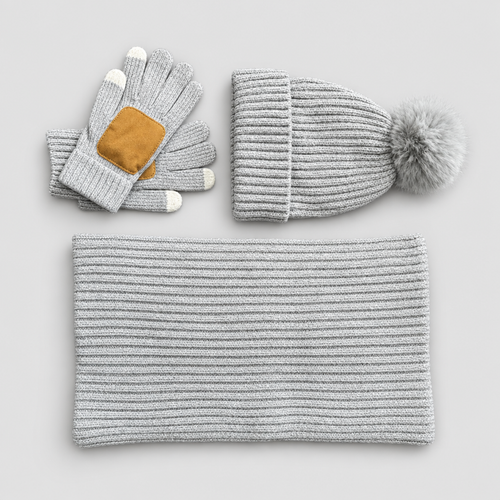 Knit winter set with hat, scarf and gloves in light grey, studio photo