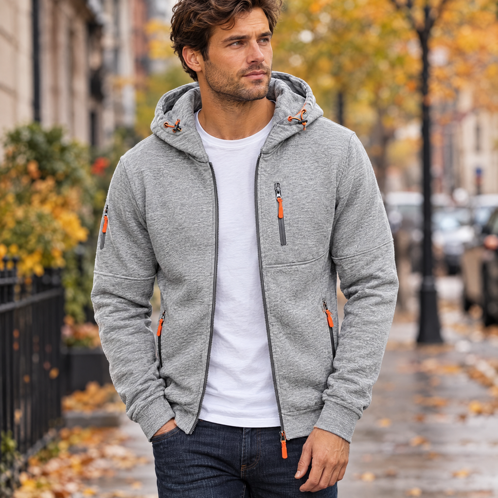 Full zip hoodie in light grey worn with jeans on a city street