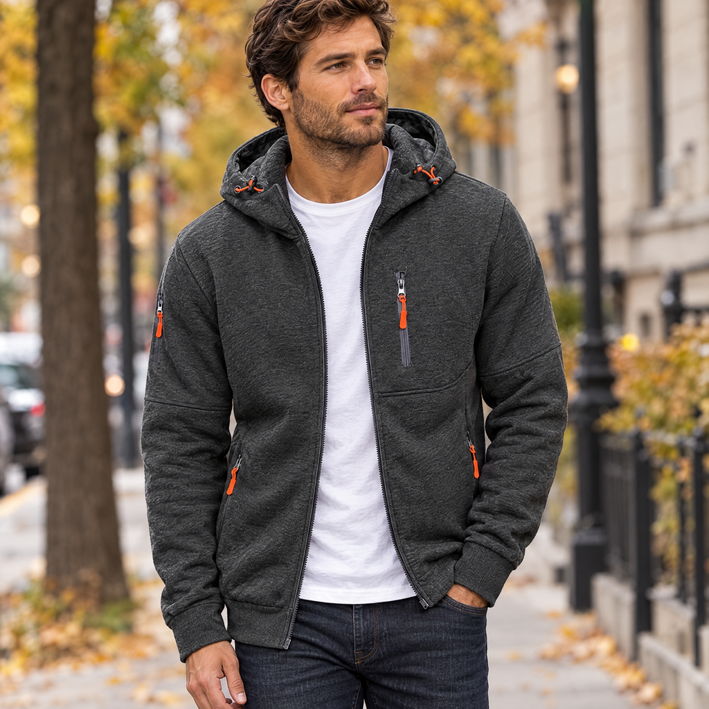 Full zip hoodie in dark grey worn with jeans on a city street