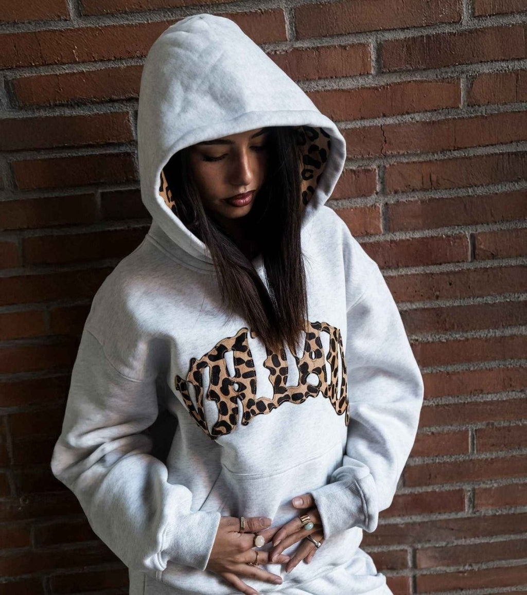 Knit hoodie with leopard print lined hood in grey, front view