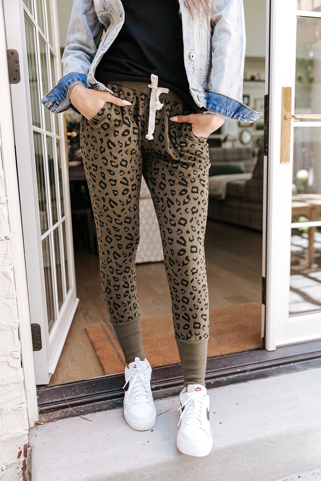 Skinny fit joggers in green leopard print, front view